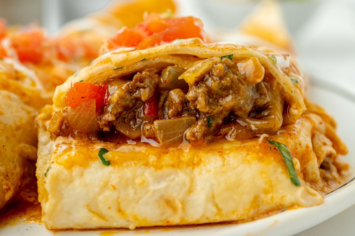 straight on shot of smothered beef burrito cut in half