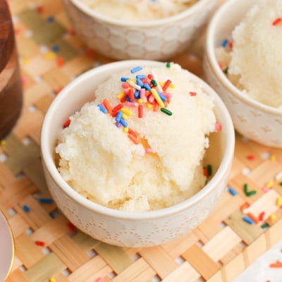angle view of a scoop of homemade snow cream with rainbow sprinkles
