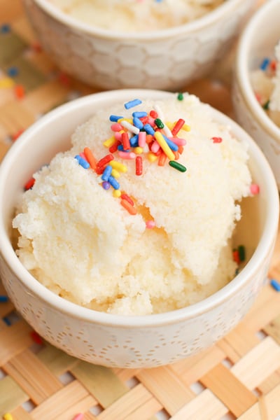 angle view of a scoop of homemade snow cream with rainbow sprinkles