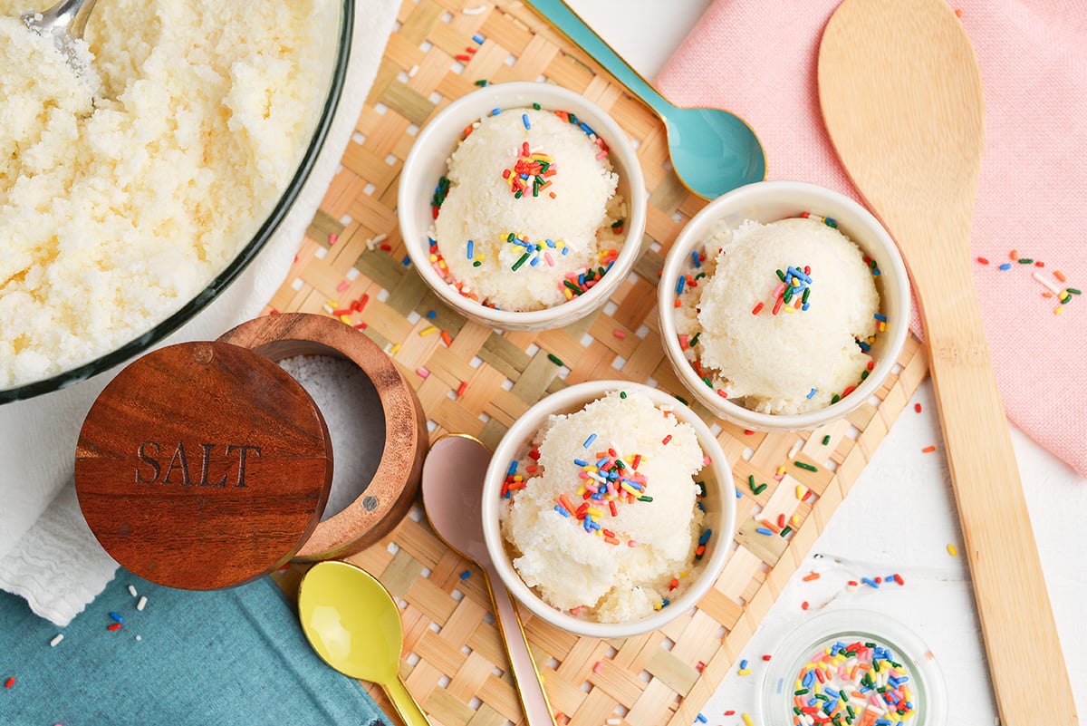 overhead of three bowls of snow cream with sprinkles