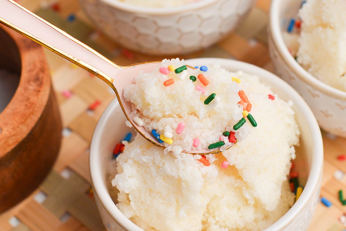 close up pink spoon of snow cream with sprinkles