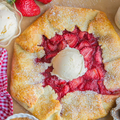 overhead shot of scoop of ice cream on top of strawberry galette