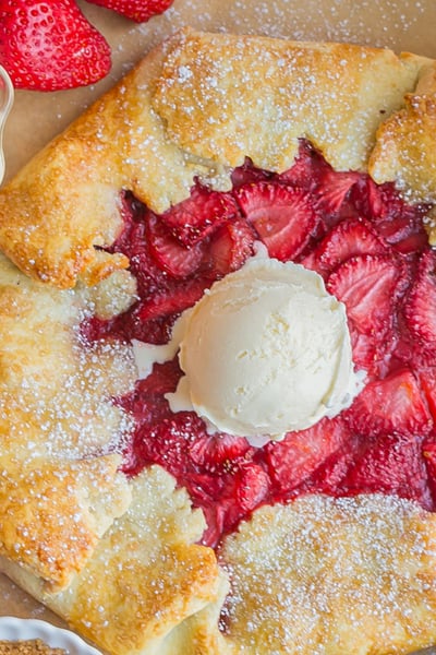 overhead shot of scoop of ice cream on top of strawberry galette