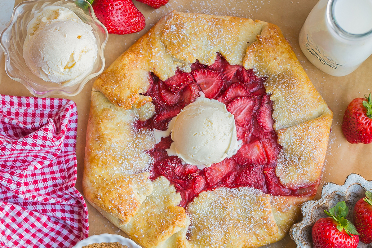 overhead shot of scoop of ice cream on top of strawberry galette