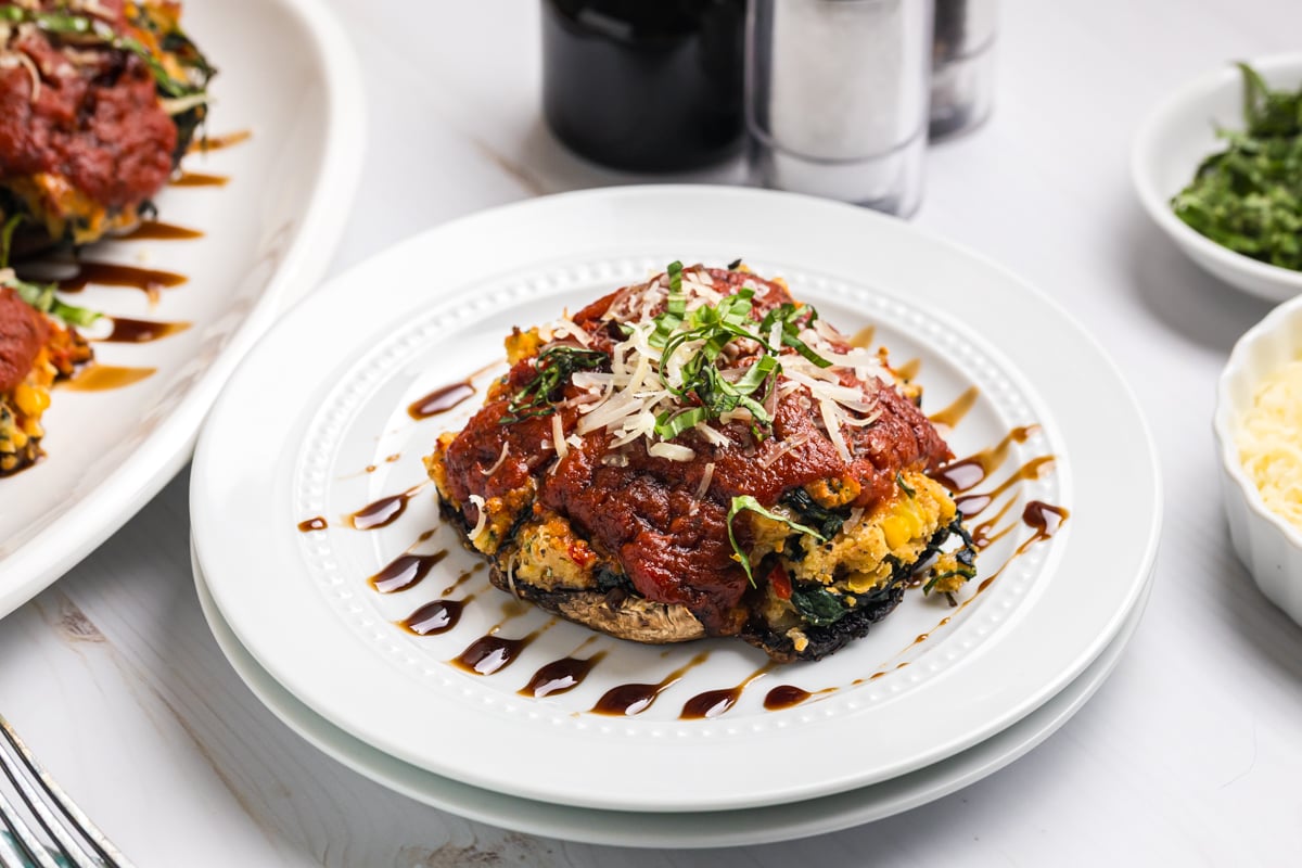 angled shot of stuffed portabella mushroom on plate