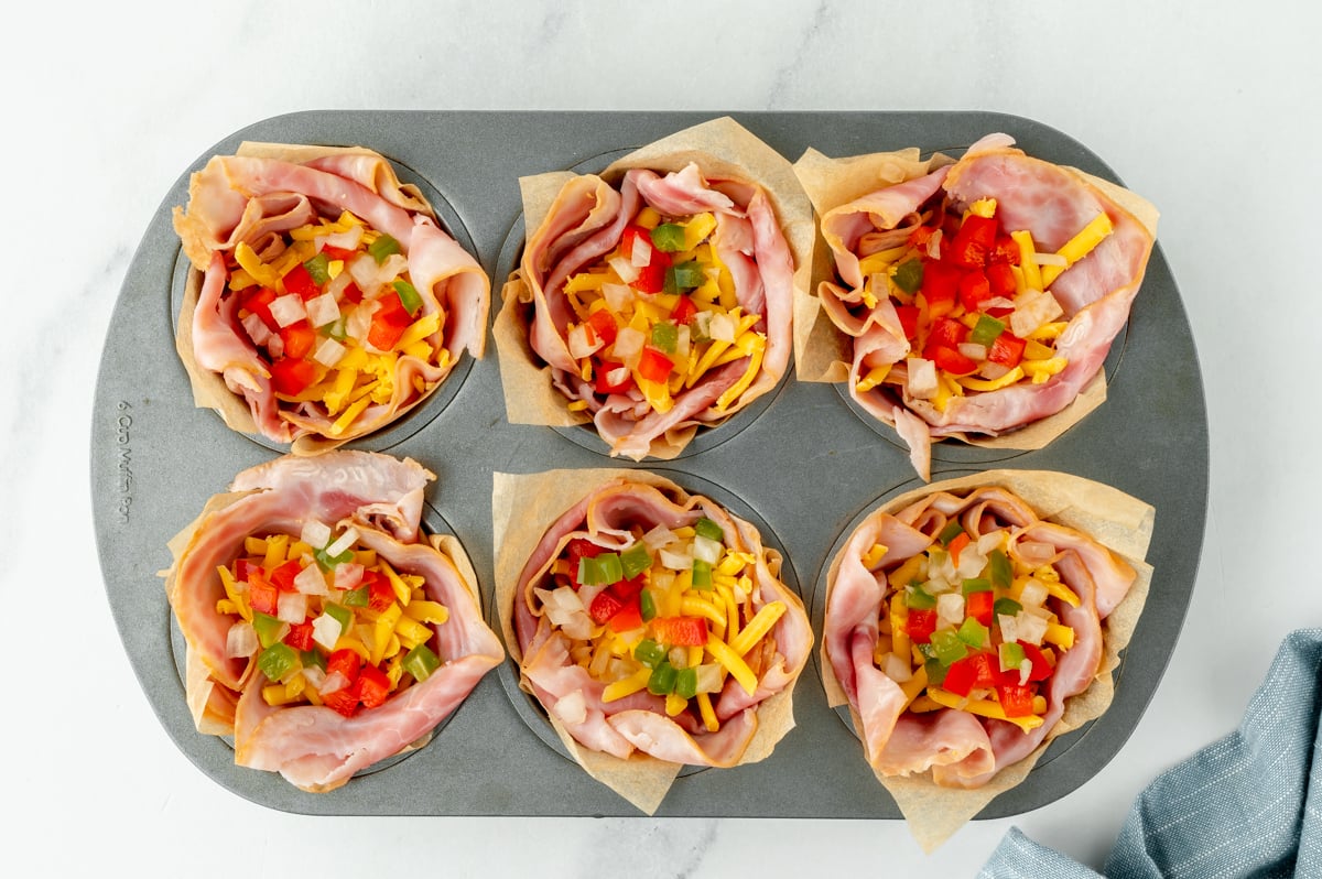 overhead shot of veggies and cheese inside ham cups