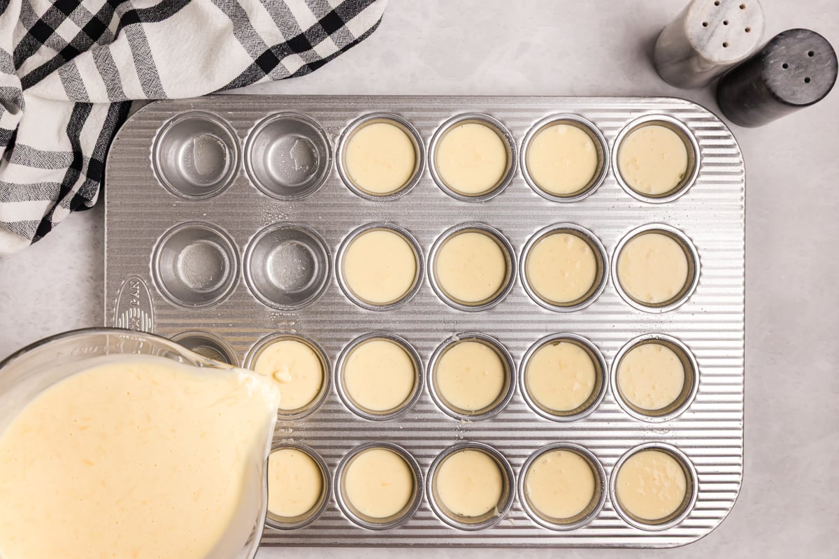 overhead shot of batter pouring into mini muffin pan