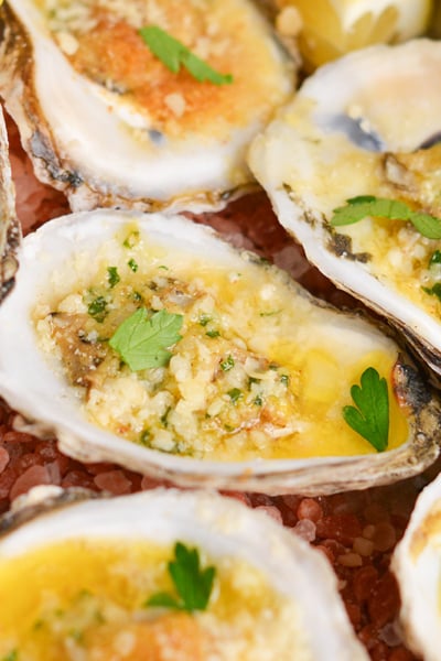 close up angled shot of garlic butter baked oysters