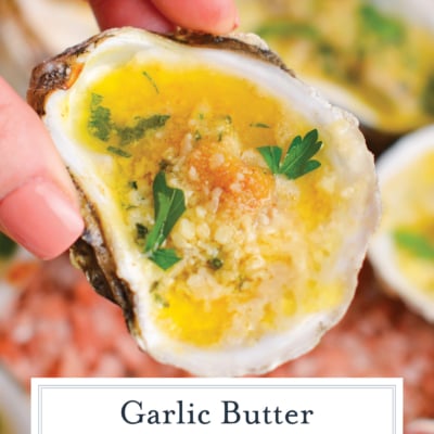 hand holding garlic butter baked oyster with text overlay