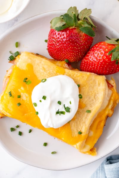 overhead shot of slice of casserole on plate with strawberries