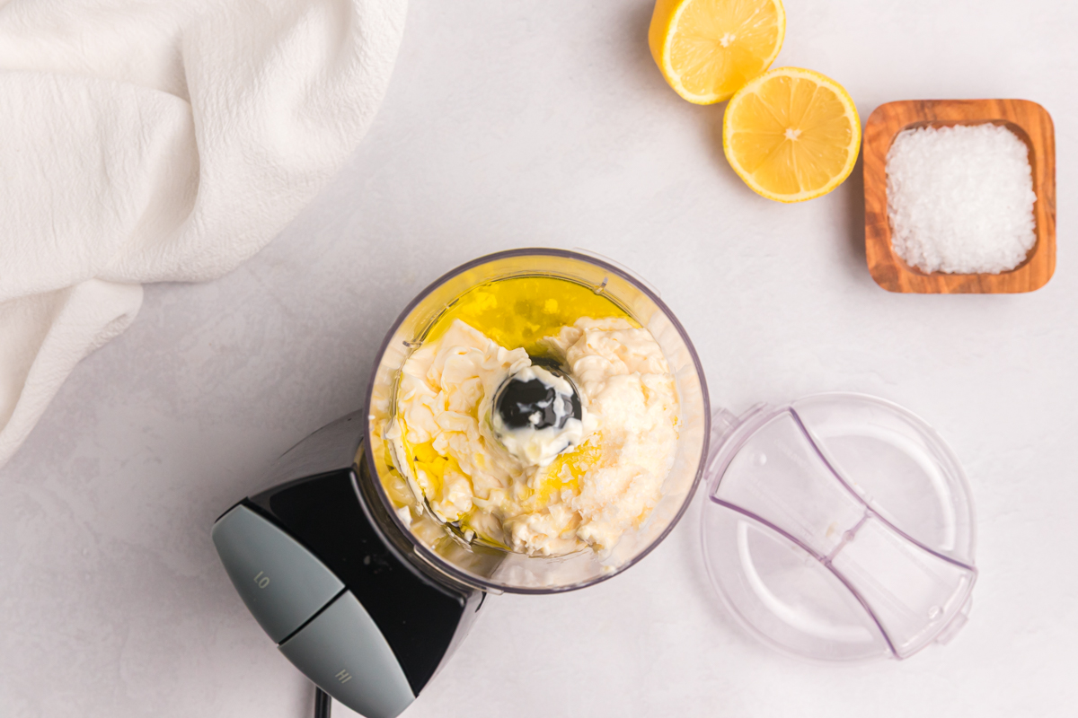 overhead shot of aioli ingredients in a food processor