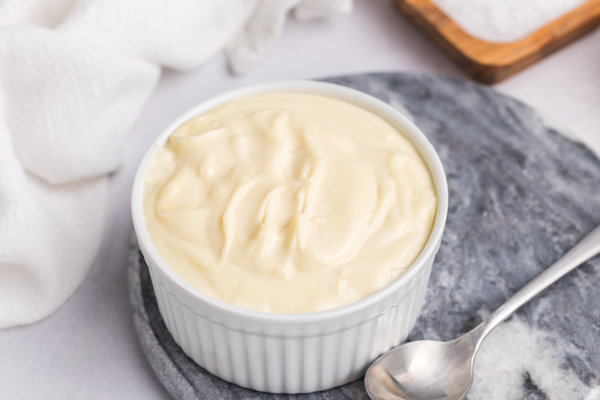 angled shot of bowl of homemade aioli sauce