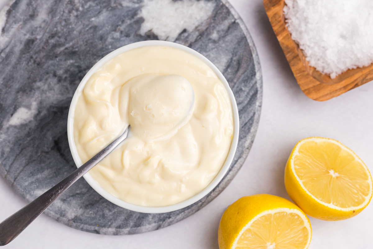 overhead shot of spoon in bowl of aioli