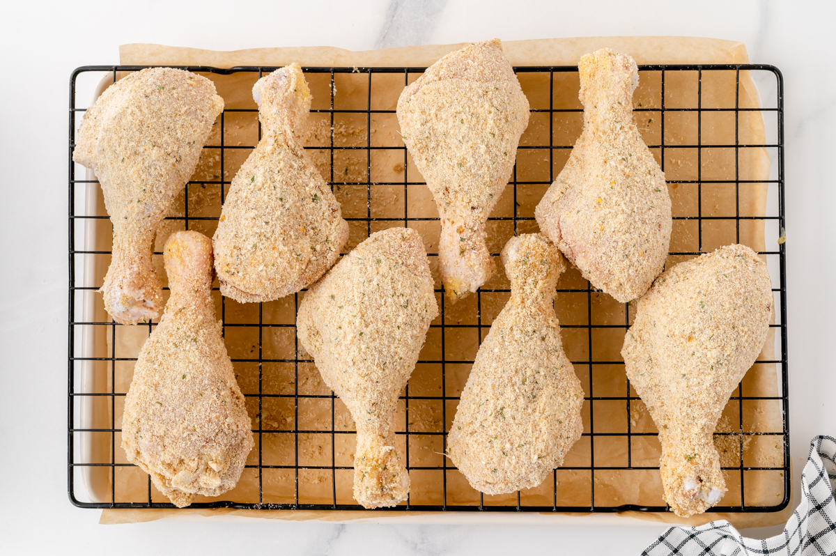 overhead shot of breaded raw chicken on cooling rack