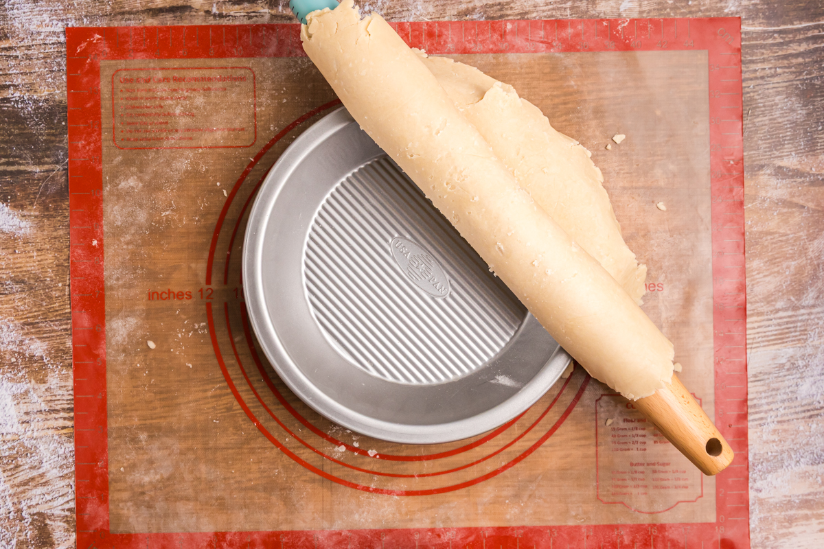 overhead shot of rolling pin putting pie crust in pie plate