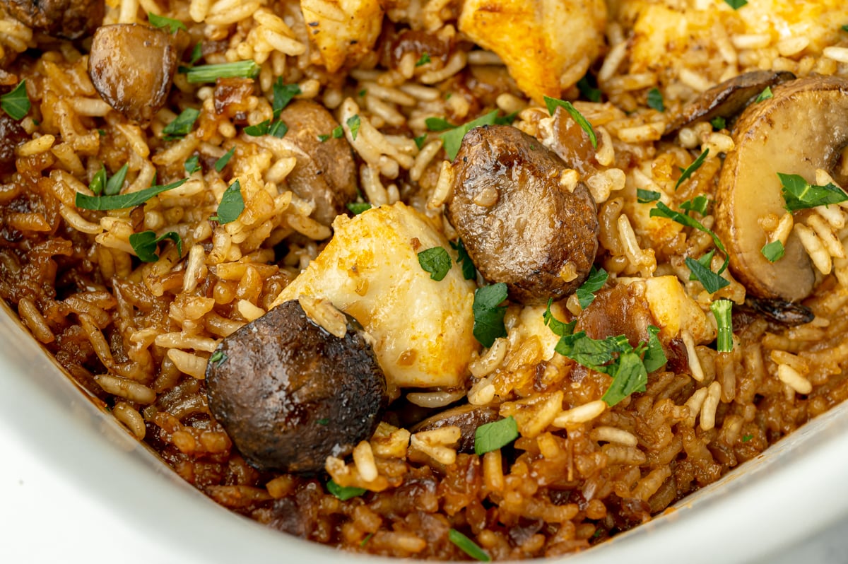 close up of mushrooms and chicken in rice