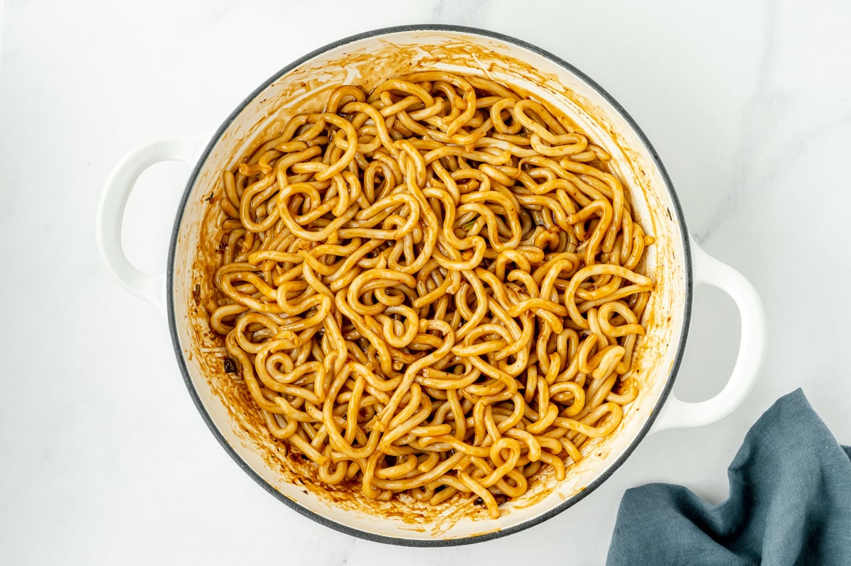 udon noodles cooking in pan