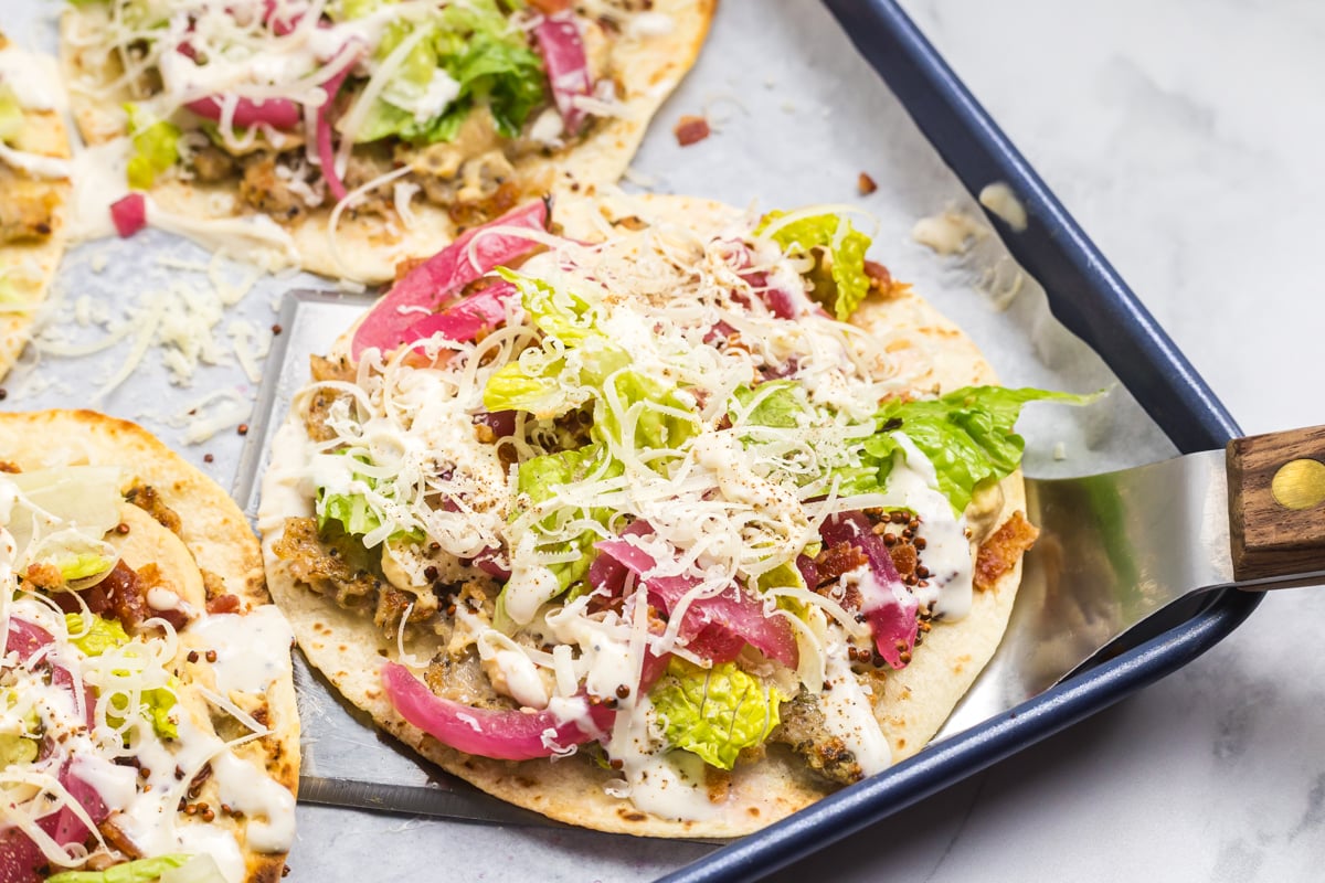 spatula scooping up taco from sheet pan