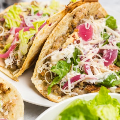 two chicken caesar smash tacos on a plate