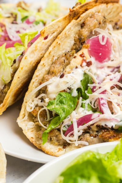 two chicken caesar smash tacos on a plate