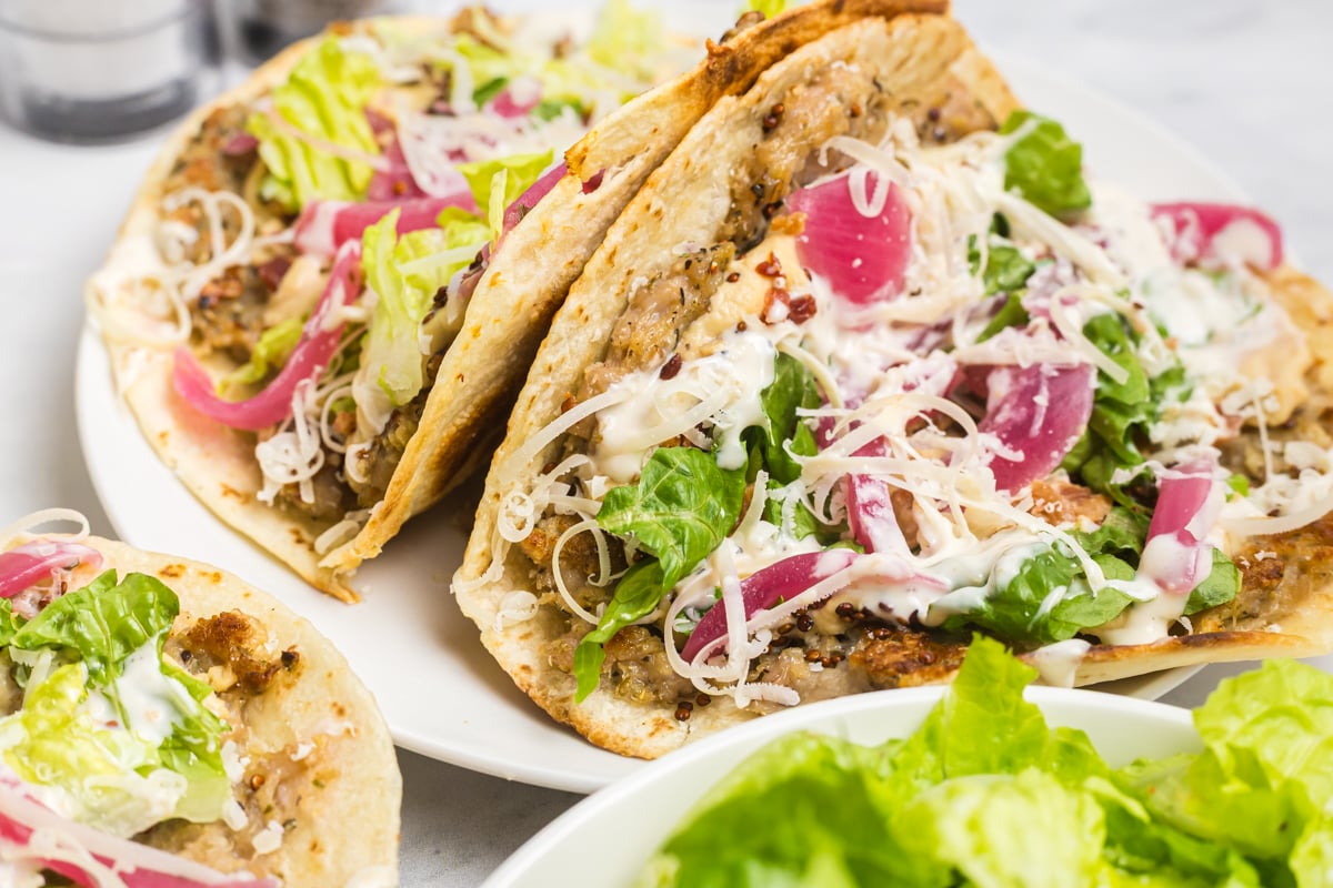 two chicken caesar smash tacos on a plate