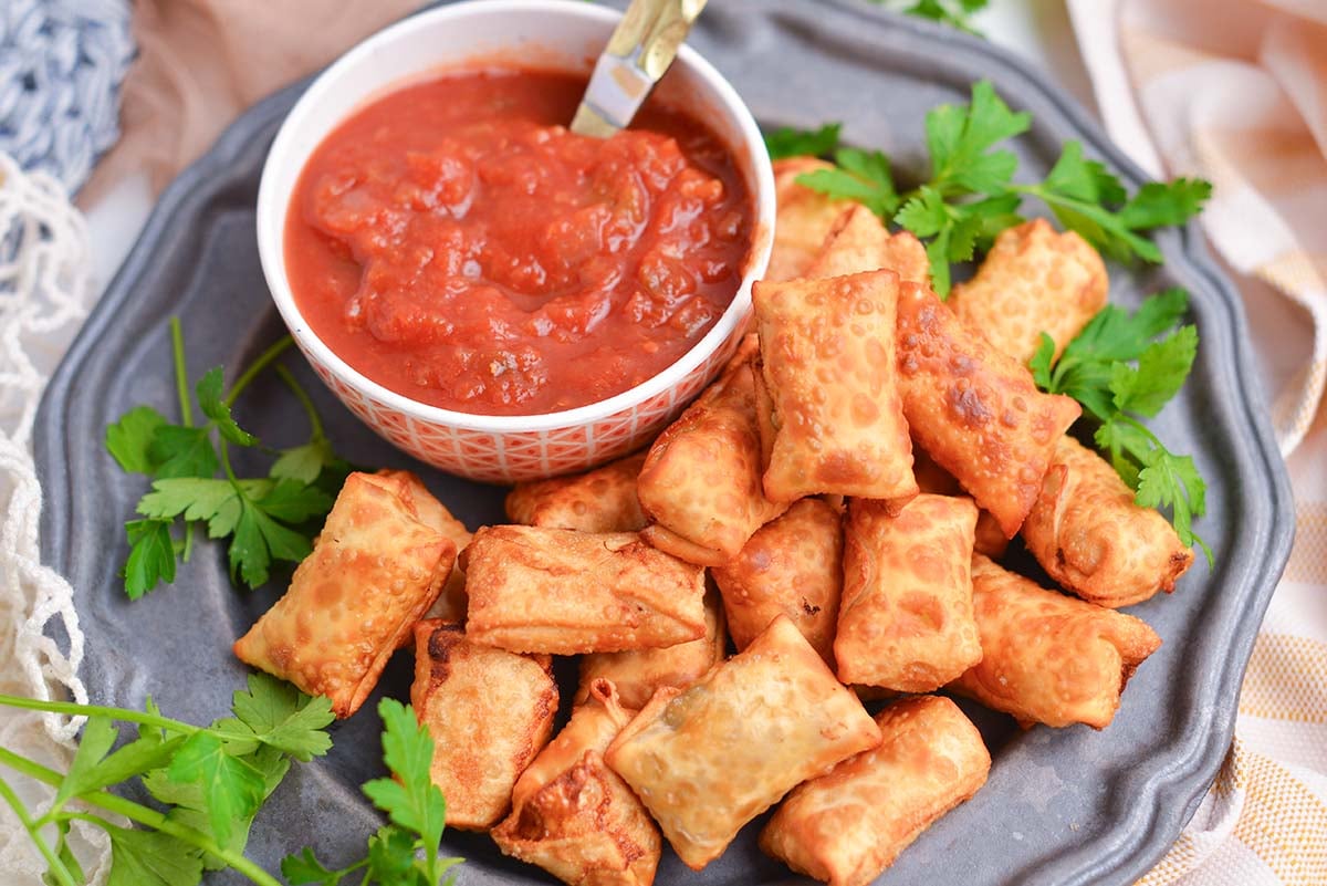 angle view of mini chile relleno bites with salsa dipping sauce