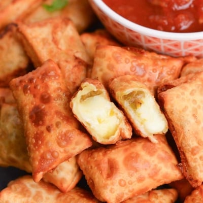 chile relleno appetizer broken in half to show cheese and chiles inside