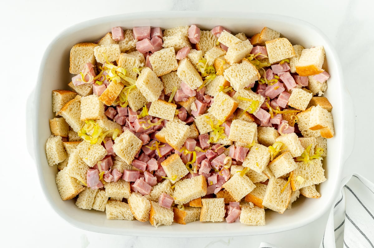 bread cubes, leeks and ham in casserole dish