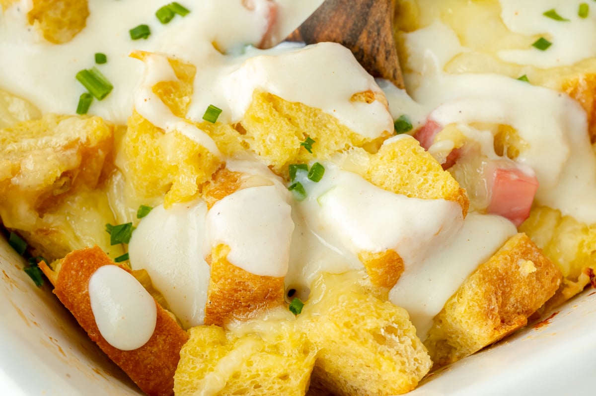 close up shot of wooden spoon in breakfast casserole