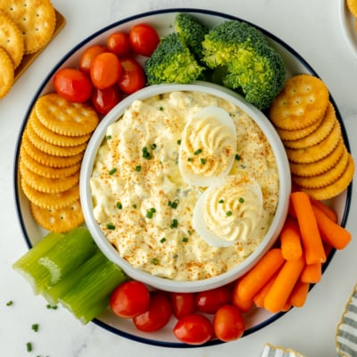 overhead shot of bowl of deviled egg dip with dippers