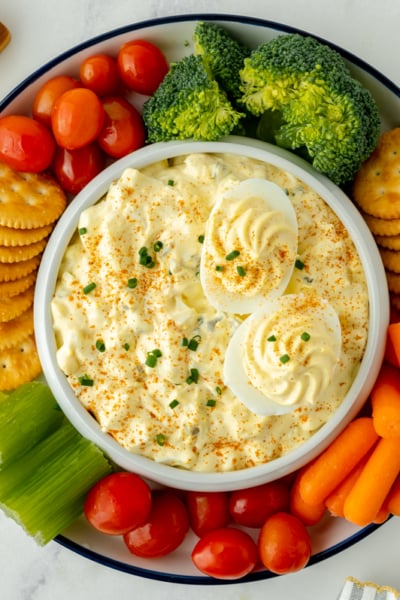 overhead shot of bowl of deviled egg dip with dippers