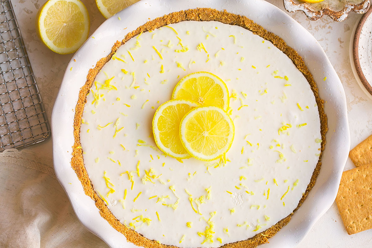 overhead shot of frozen lemonade pie topped with three lemon slices