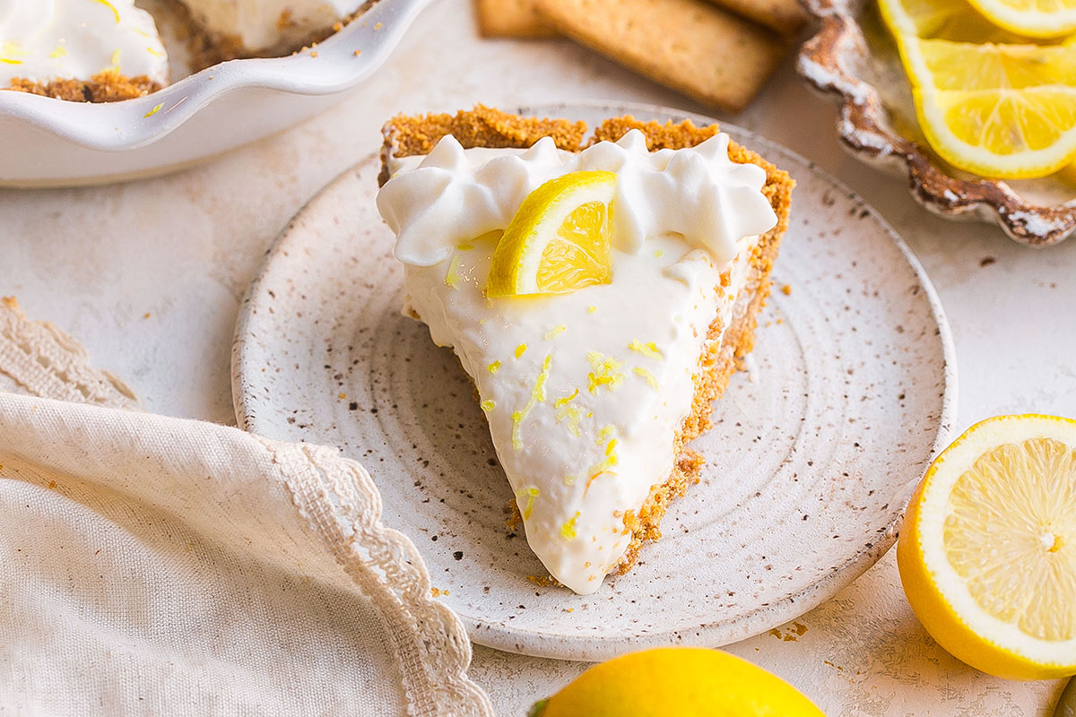 angled shot of slice of lemon pie on plate