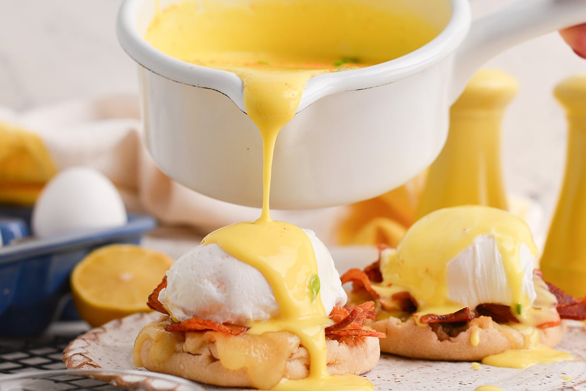 blender hollandaise sauce poured over eggs Benedict