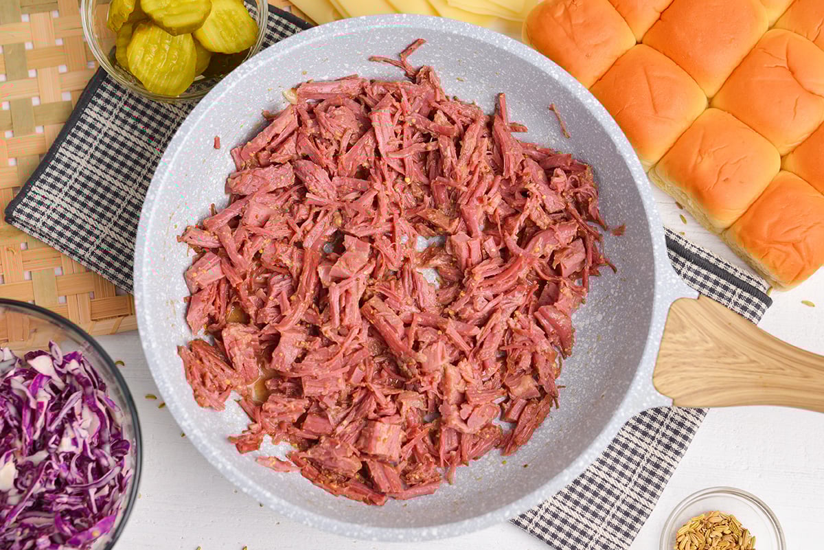 skillet with leftover corned beef tossed in a mustard sauce