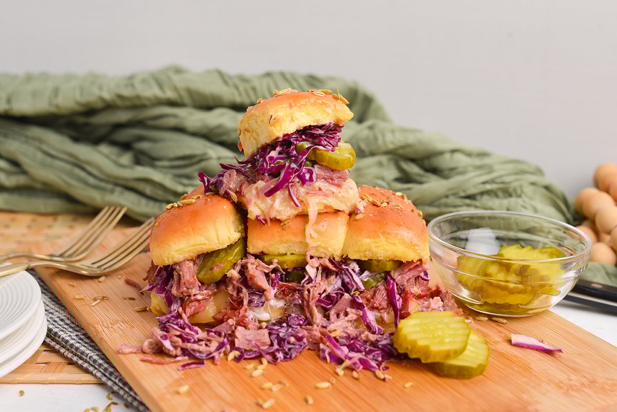 stack of leftover corned beef sandwiches on a cutting board