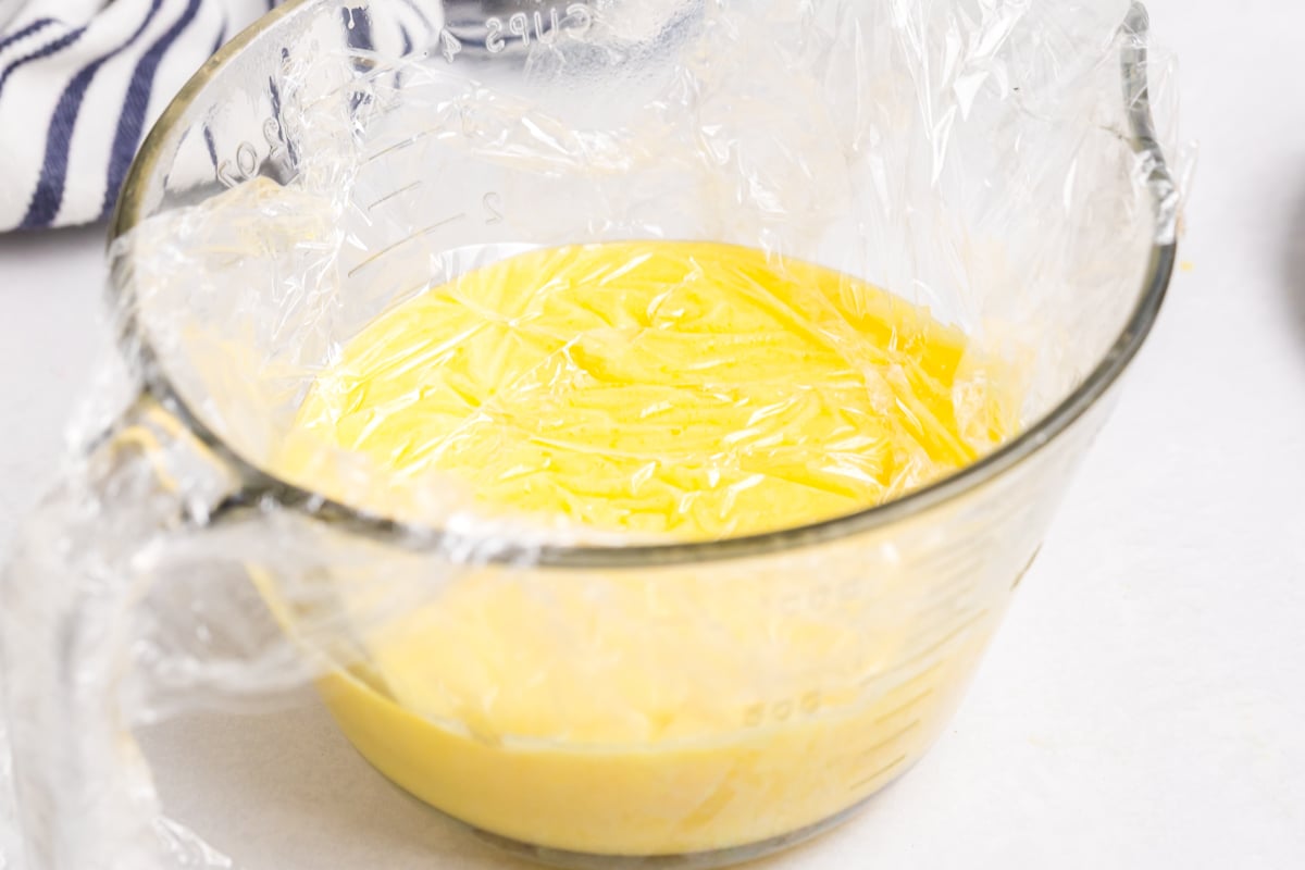plastic wrap on surface of lemon curd in bowl
