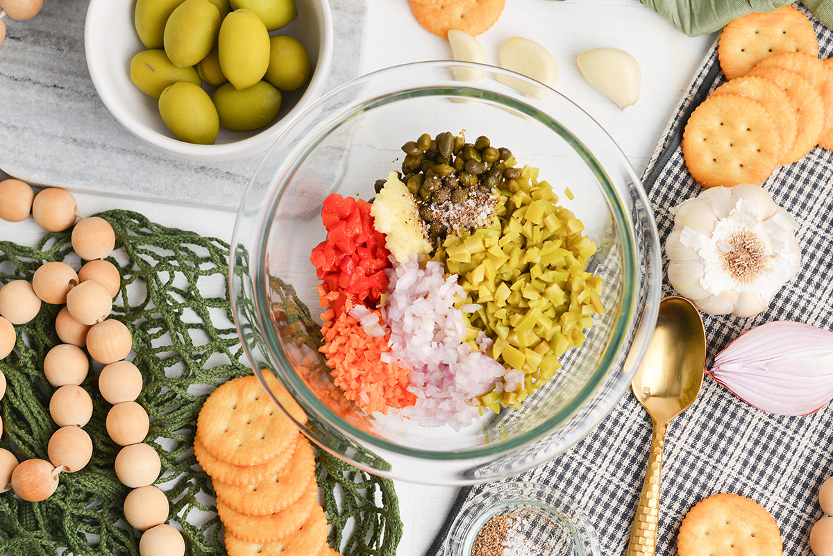 overhead mixing bowl with green olive tapenade ingredients