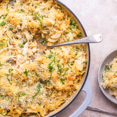 spooning out chicken tetrazzini into a smaller plate