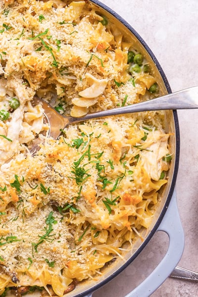 spooning out chicken tetrazzini into a smaller plate