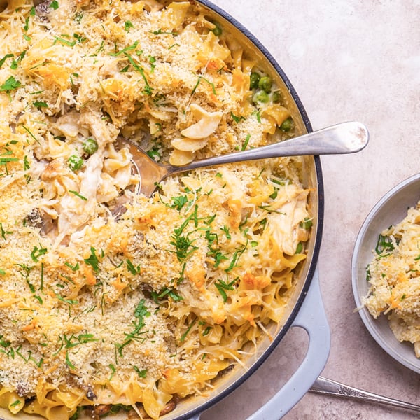 spooning out chicken tetrazzini into a smaller plate