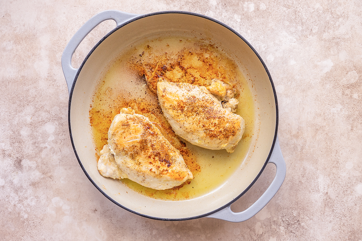 seasoned chicken breasts browned in a pan