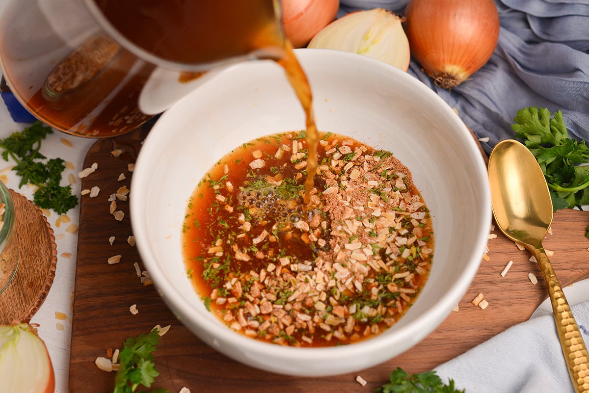 broth pouring into Homemade onion soup mix