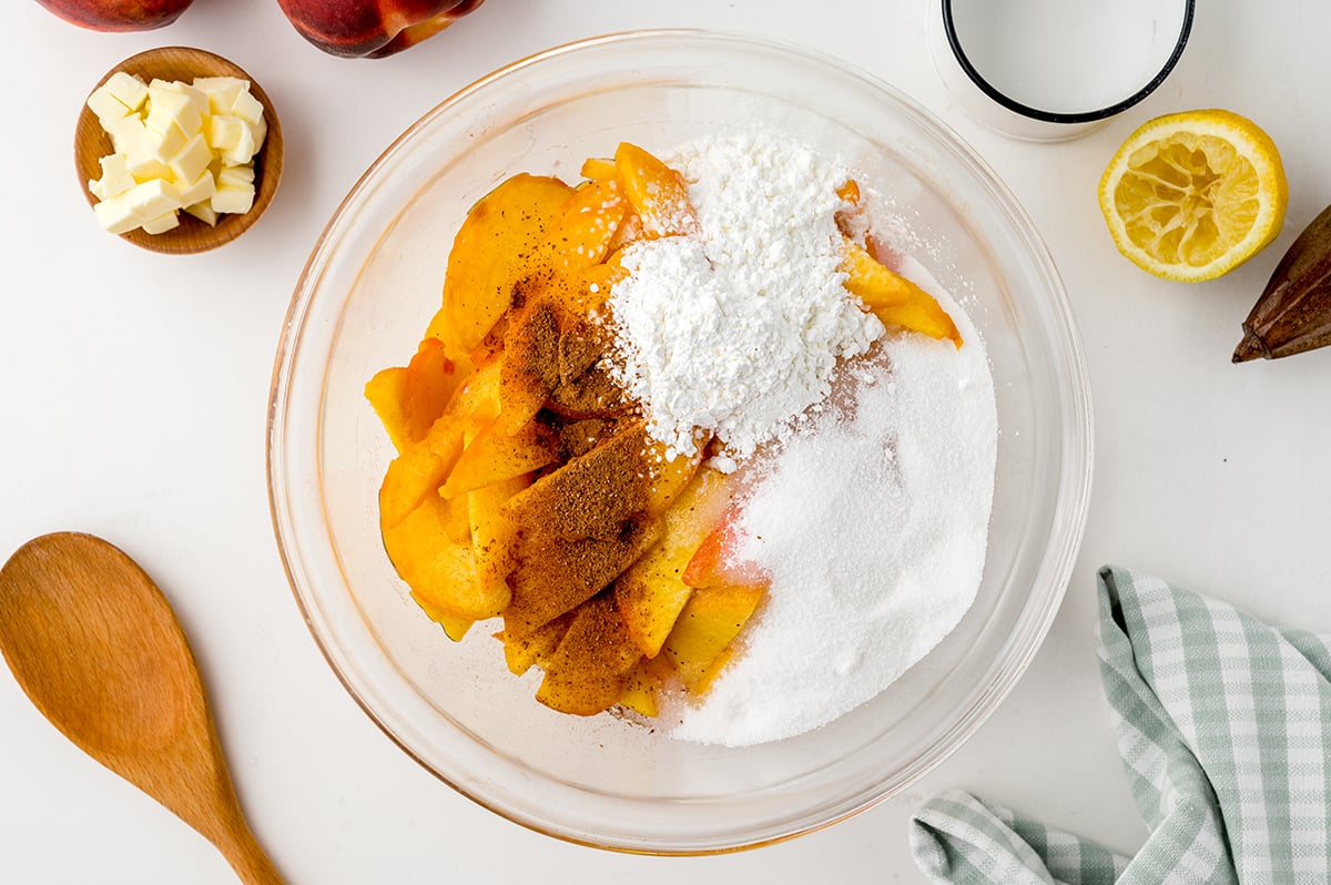 overhead shot of peach pie filling ingredients in bowl