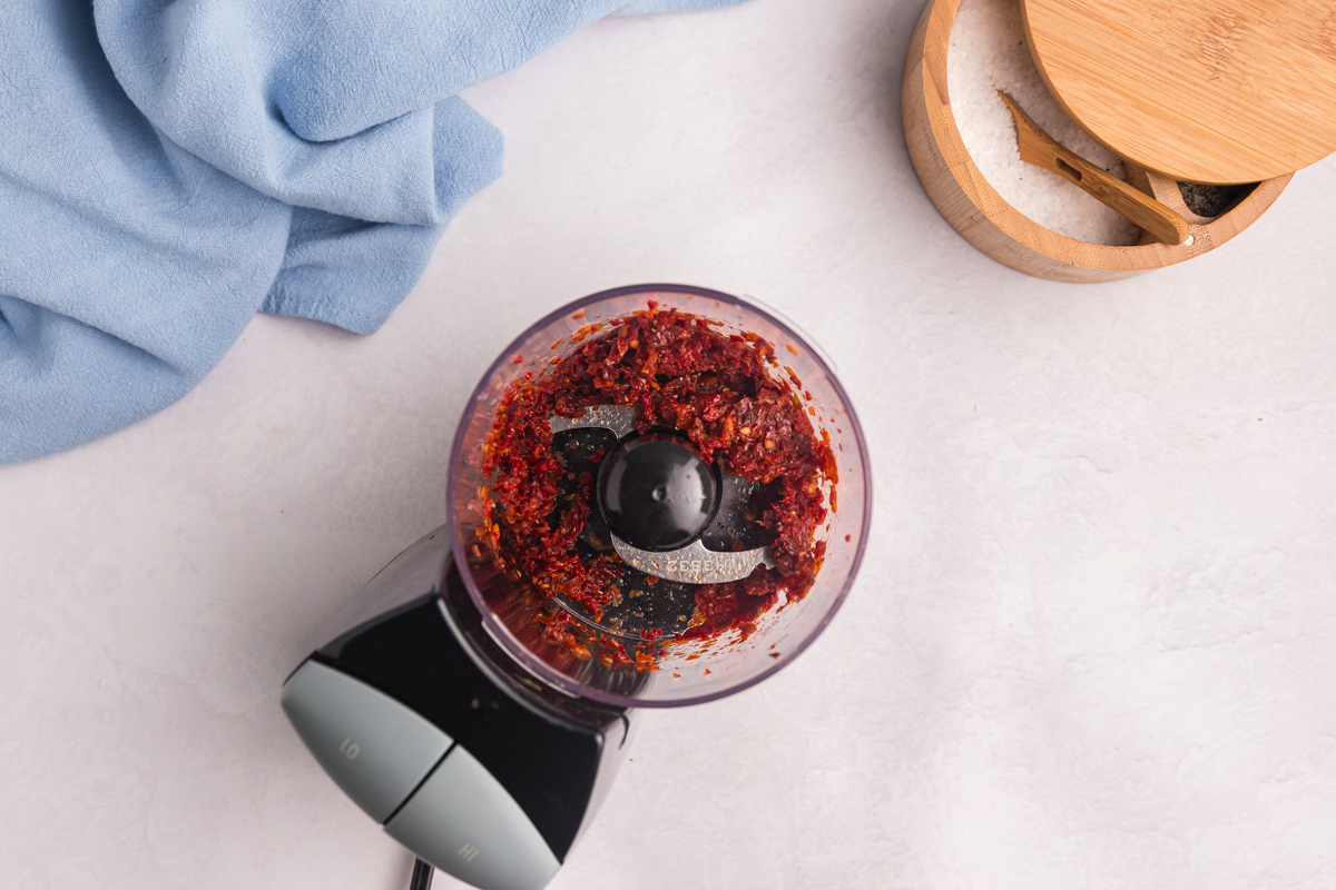 overhead shot of sundried tomatoes in food processor