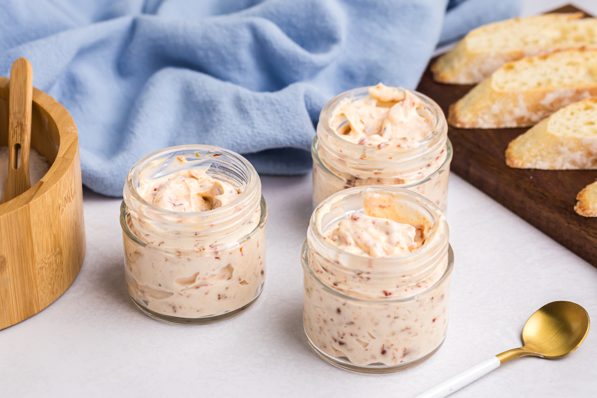 angled shot of three jars of sun dried tomato aioli