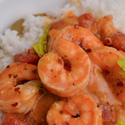 close up of gently curled shrimp in a creole sauce