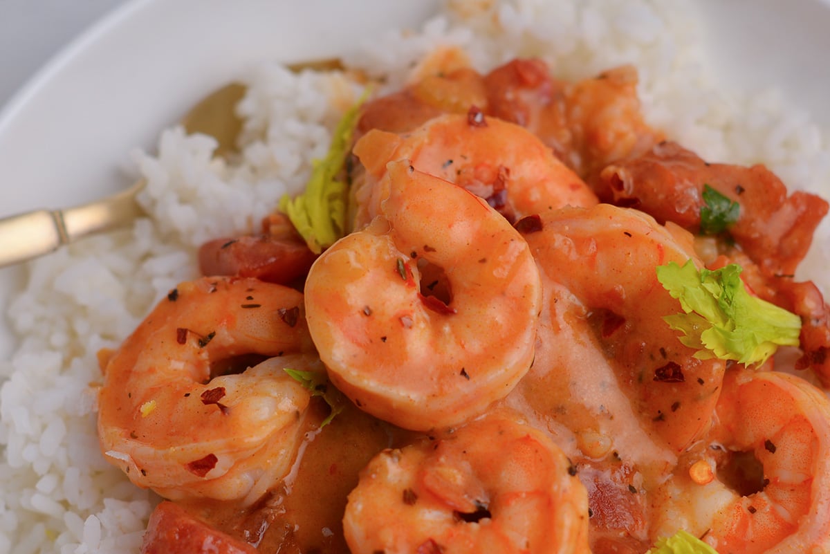 close up of gently curled shrimp in a creole sauce