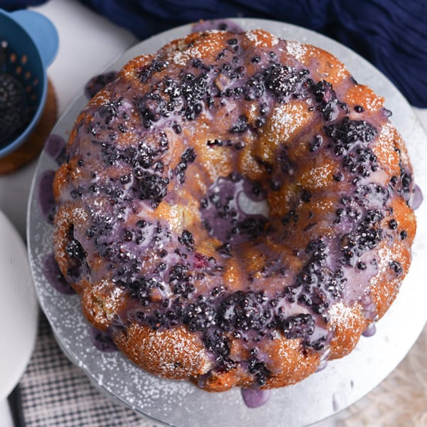 Blackberry bundt cake served in slices with glossy blackberry glaze