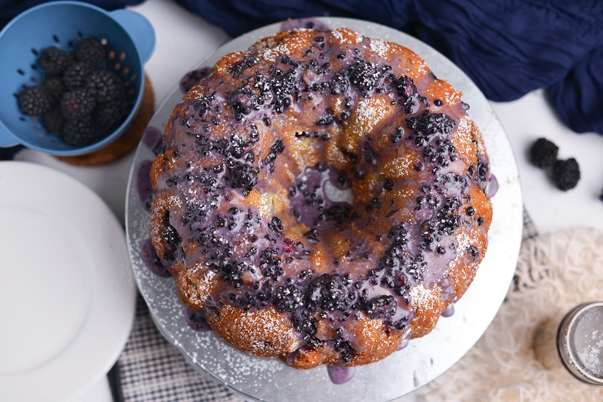 Blackberry bundt cake served in slices with glossy blackberry glaze